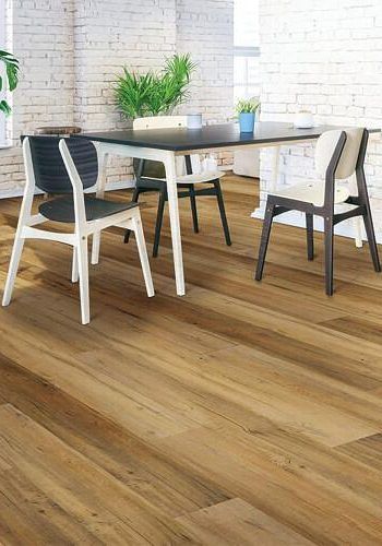 A dining room with a table and chairs on a wooden floor.