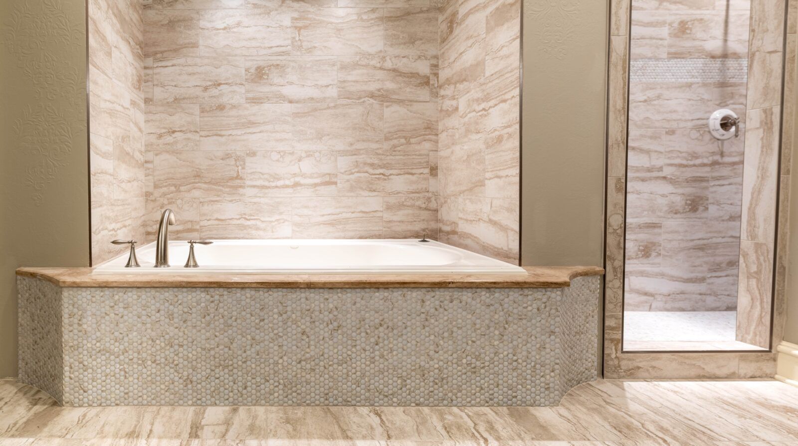 A bathroom with a bathtub and a walk in shower.