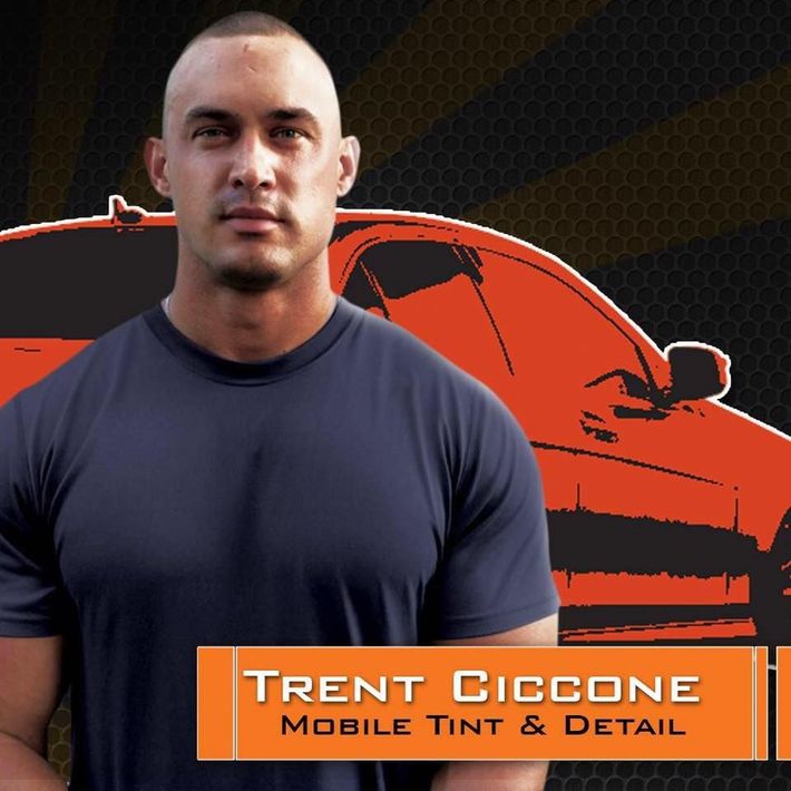 Trent Ciccone mobile tint and detail stands in front of an orange car