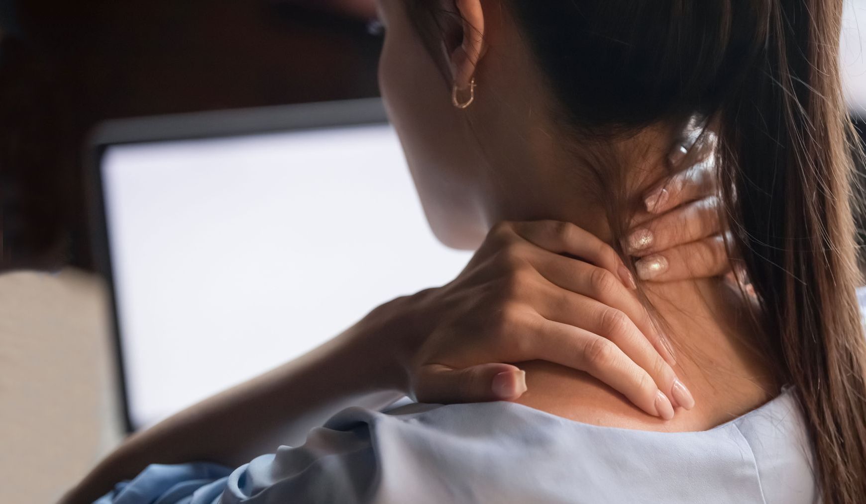 Woman holding her neck 