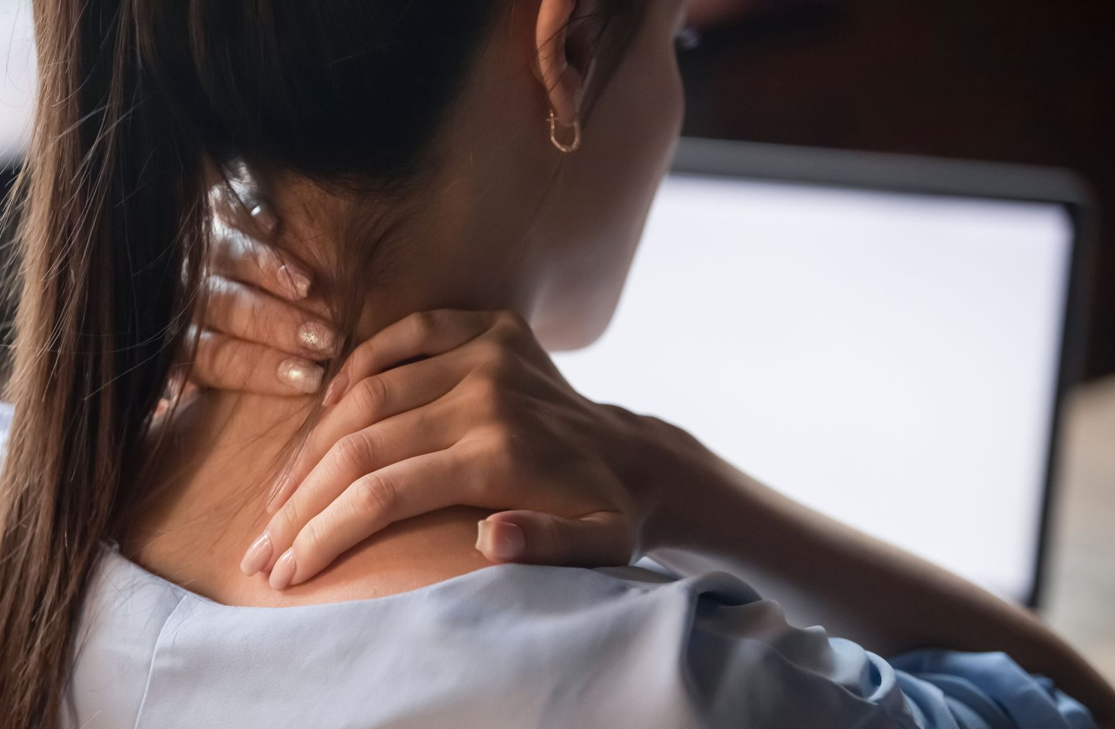 Woman holding her neck 