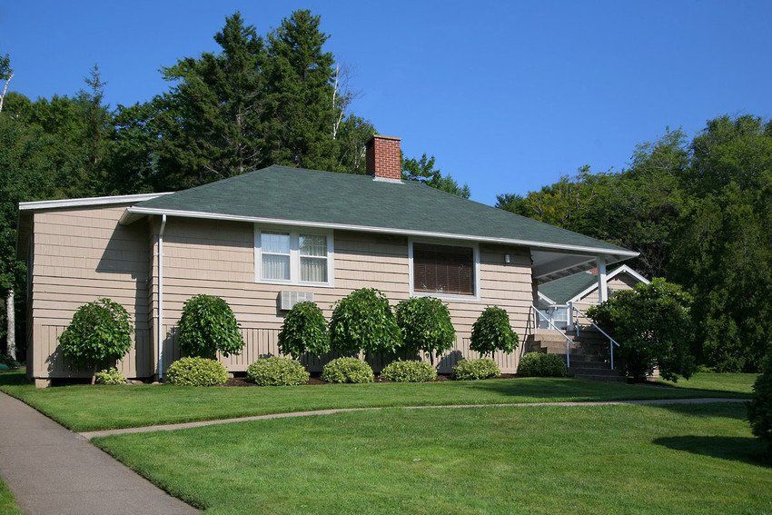 A well landscaped old fashioned bungalow.