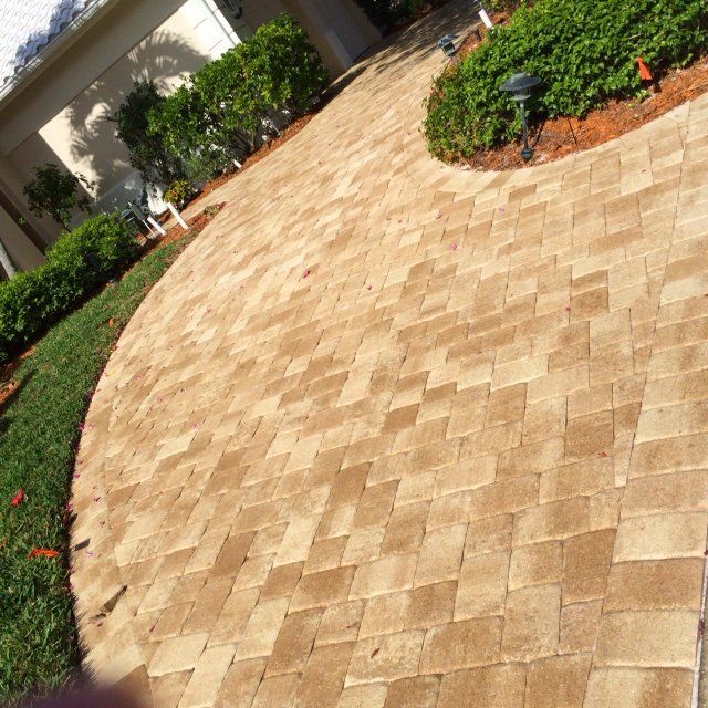 A brick walkway in front of a house