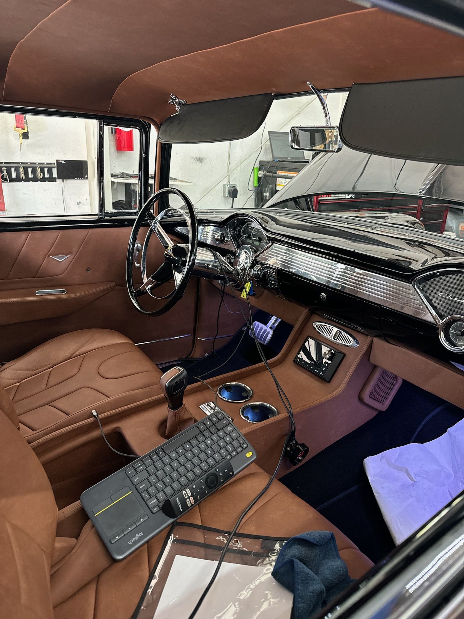 The interior of a car with a keyboard on the dashboard.