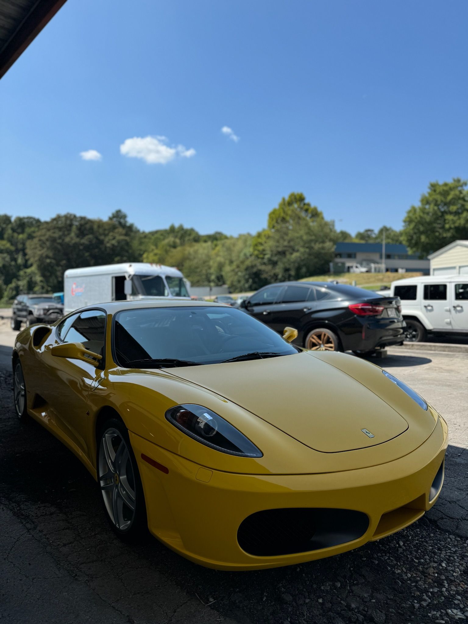 A yellow sports car is parked in a parking lot.