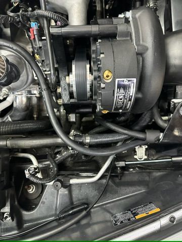 A close up of a car engine with a turbocharger.