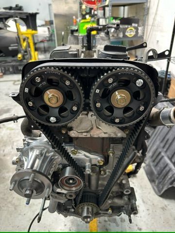 A car engine is being worked on in a garage.