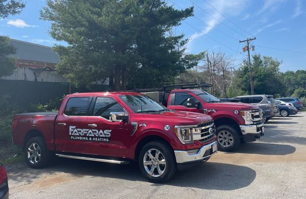 A row of red pickup trucks parked in a parking lot.