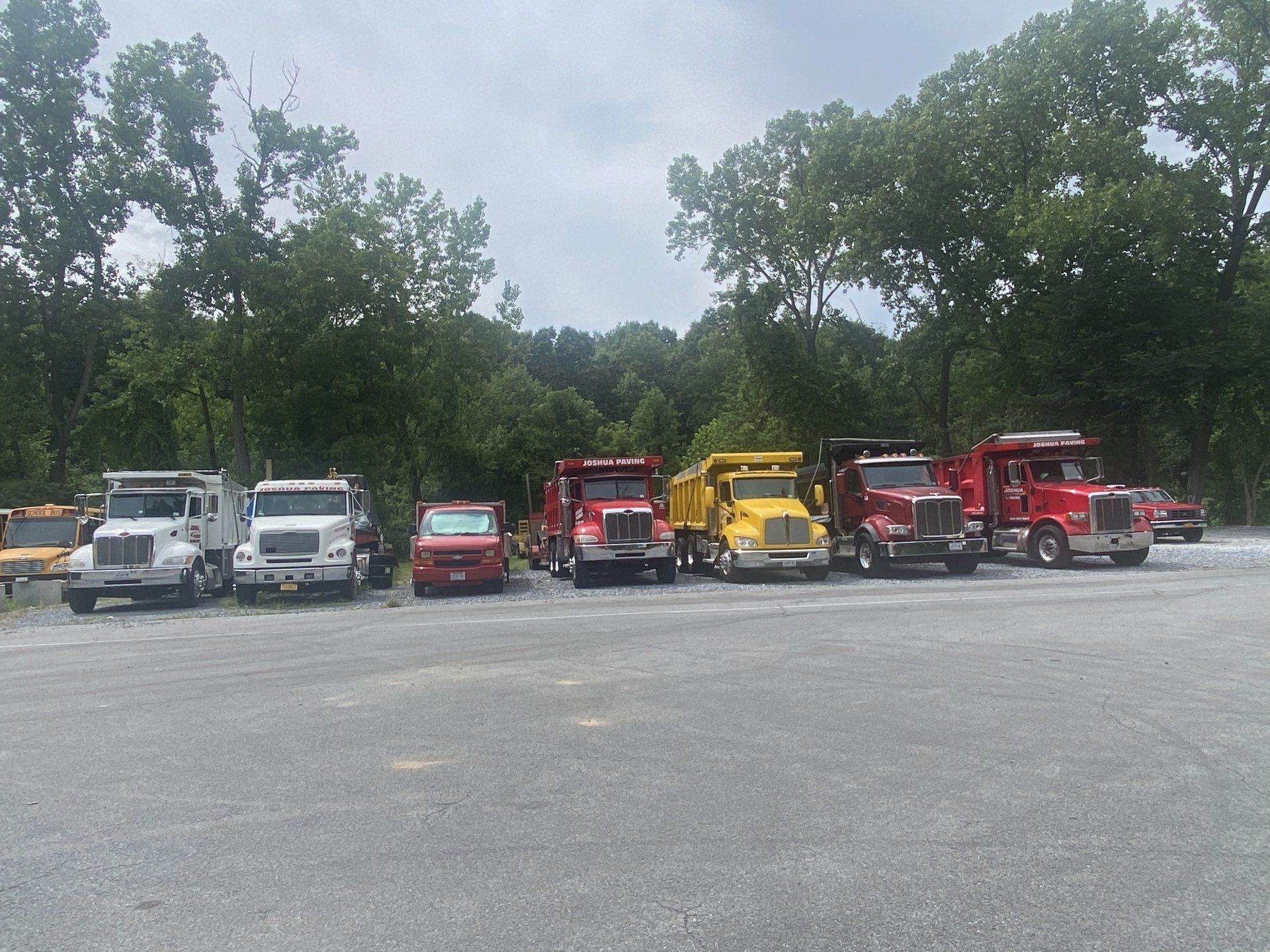 Lined up Joshua Paving Inc trucks