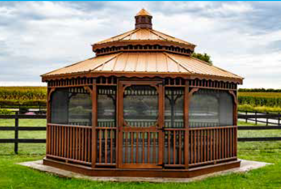 Wooden gazebo with screened walls and copper-colored roof in a grassy yard.