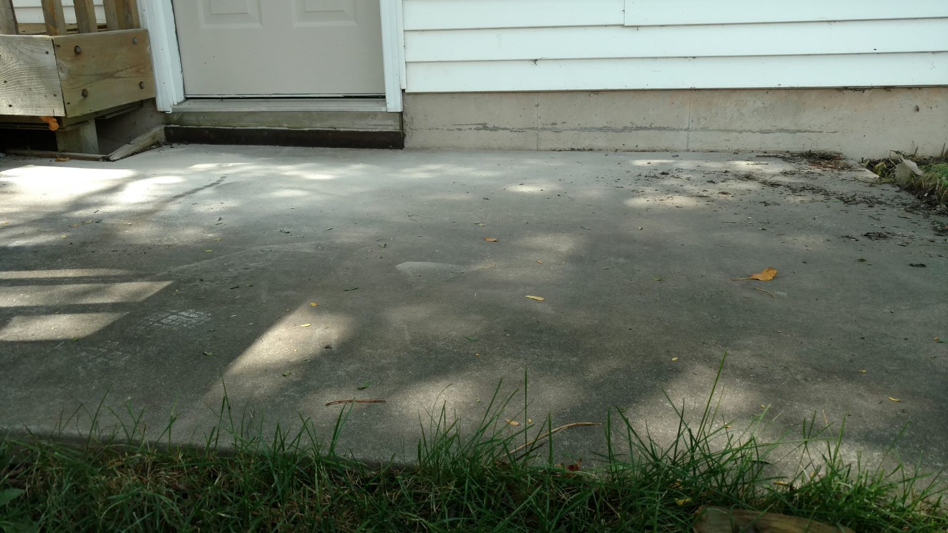 A concrete patio in front of a house - before