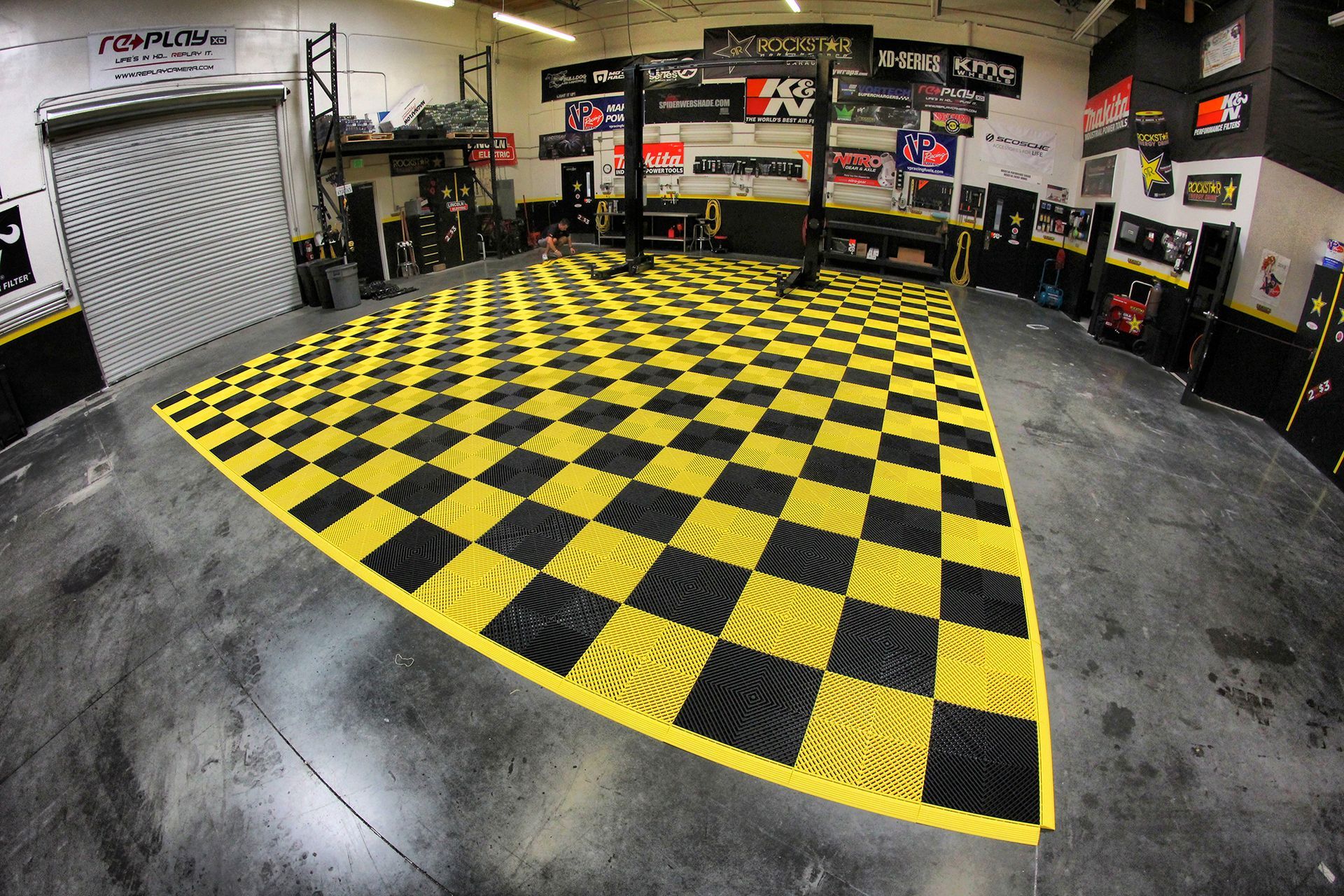 A black and yellow checkered floor in a garage