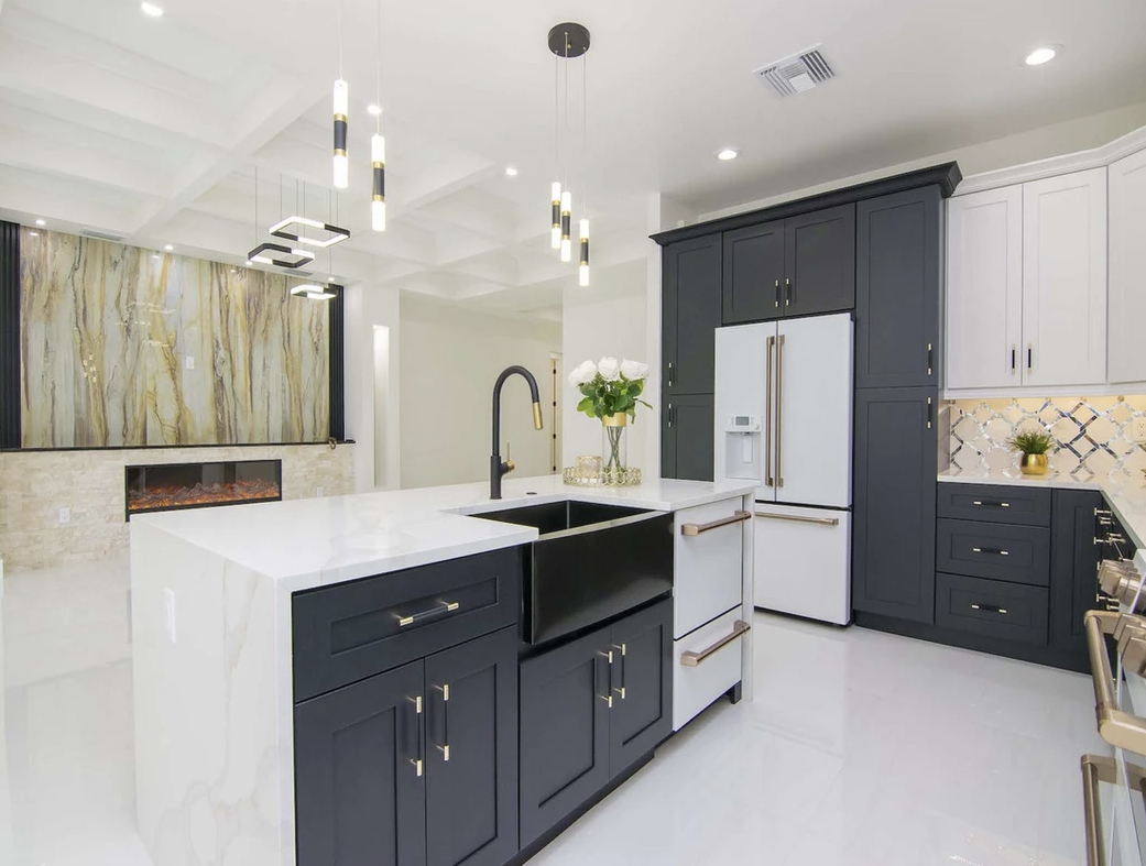 A kitchen with black cabinets and white counter tops