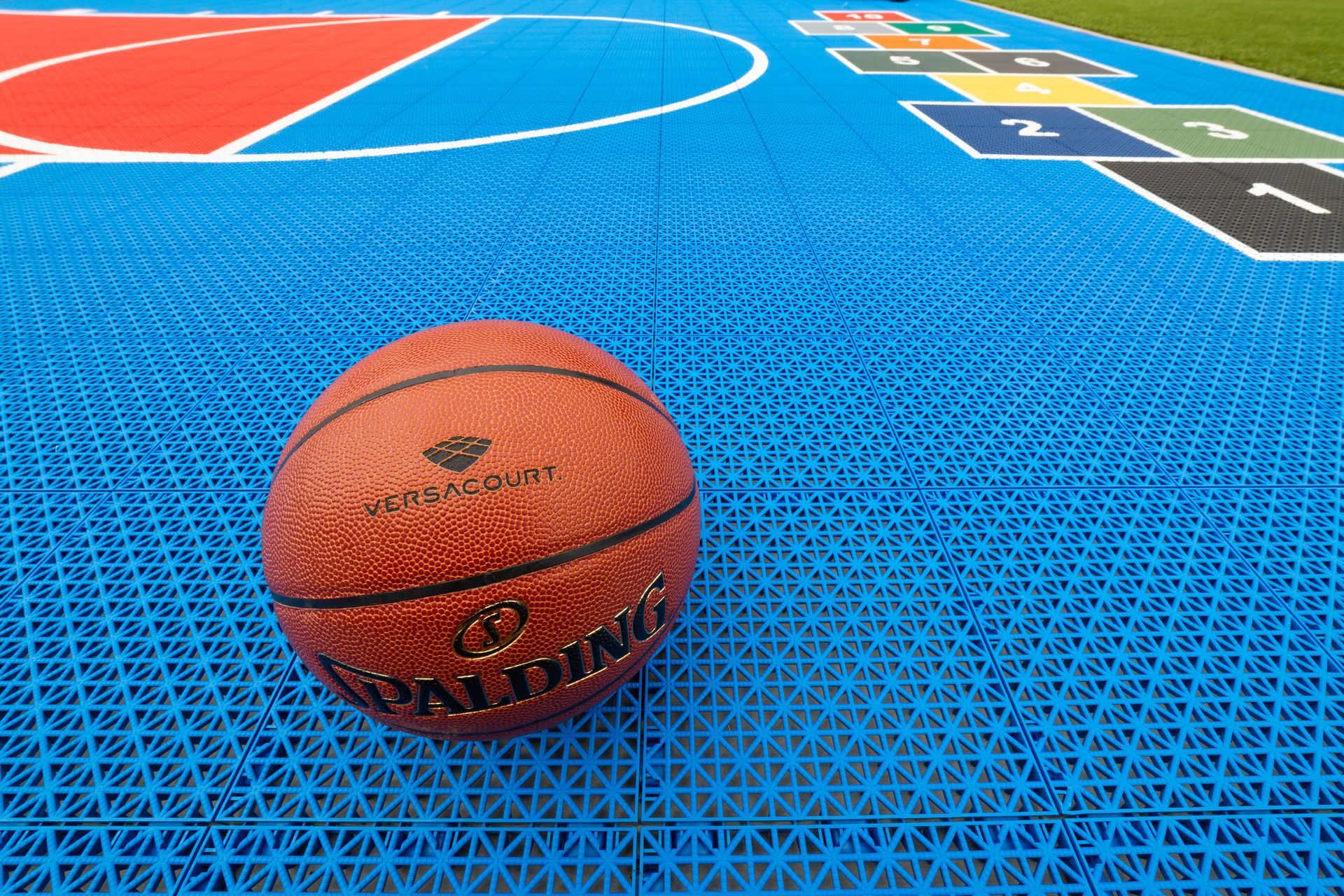 A basketball is sitting on top of a basketball court.