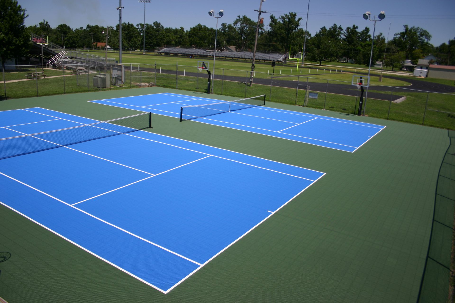 A tennis court with blue lines and white lines