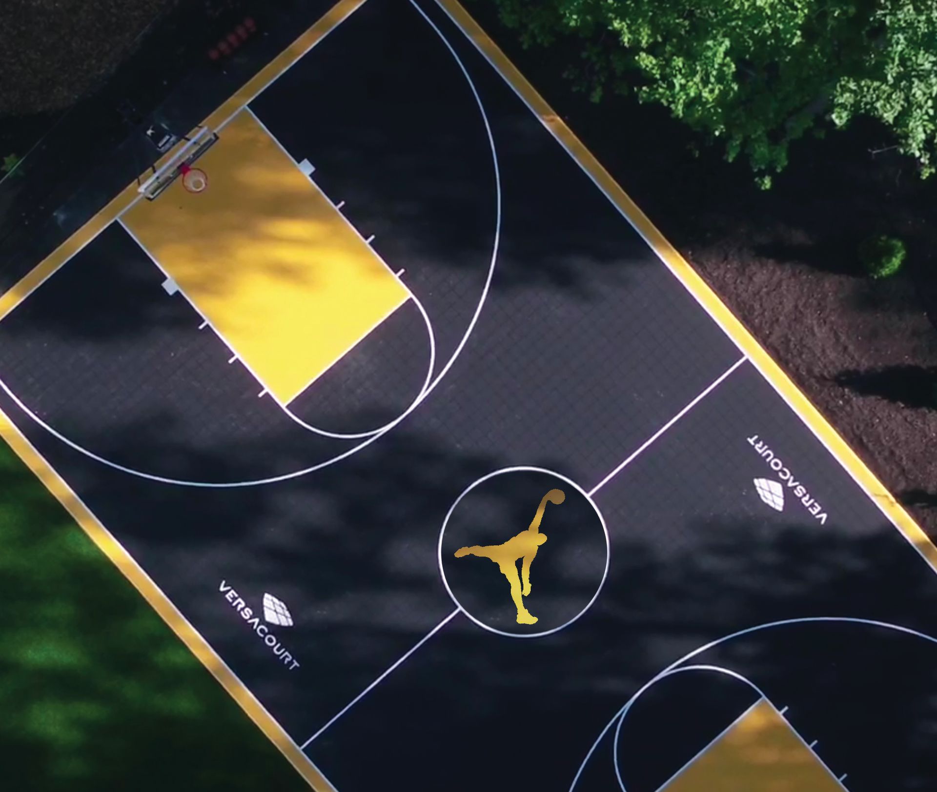 An aerial view of a black and yellow basketball court