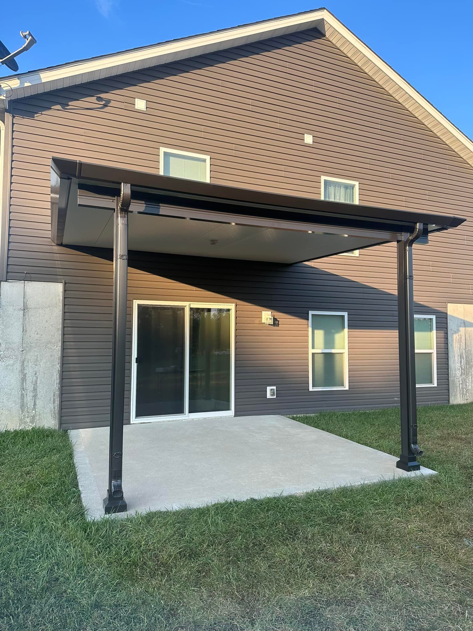 A house with a covered patio in front of it.