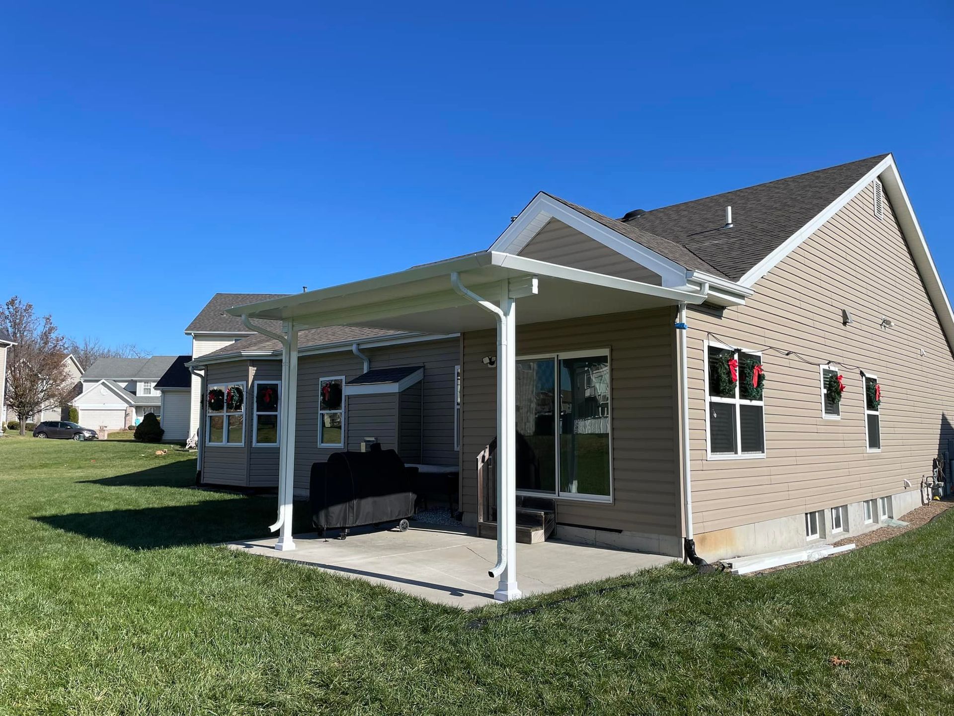 A house with a covered patio in the backyard.