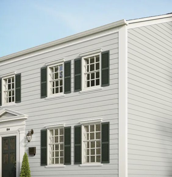 A white house with black shutters on the windows.