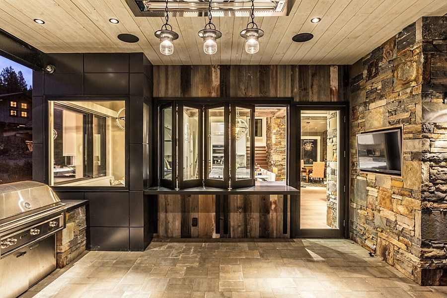 A large room with a lot of windows and a grill.