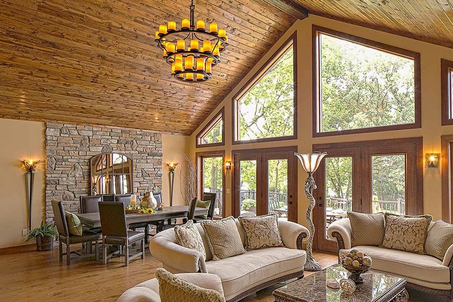 A living room with a vaulted ceiling and lots of windows