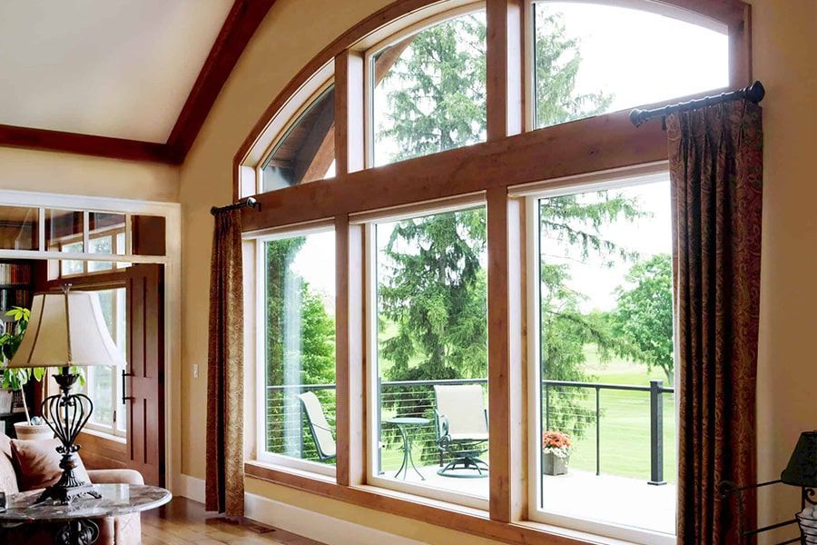 A living room with a lot of windows and a balcony