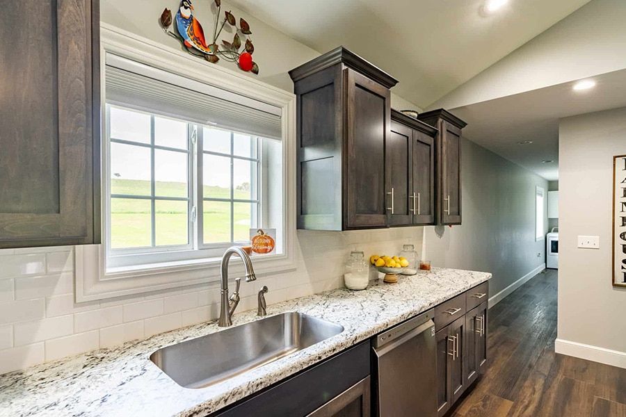 A kitchen with stainless steel appliances and granite counter tops.