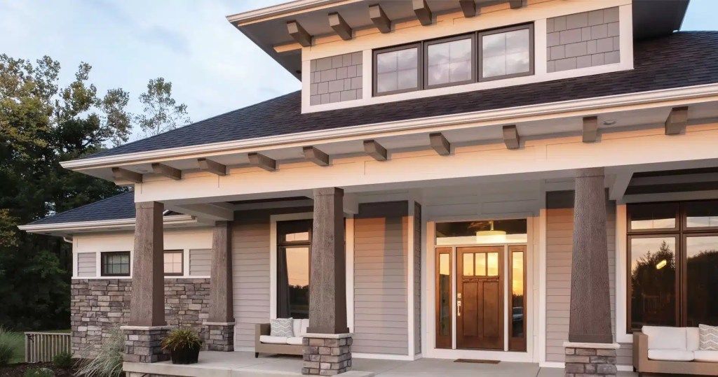A large house with a large porch and lots of windows