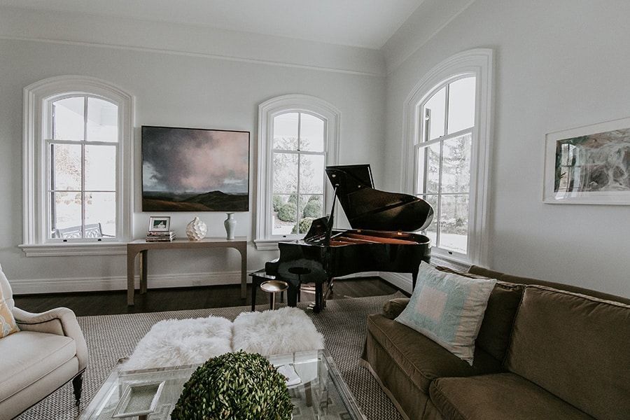 A living room with a piano and a couch.