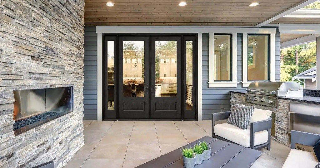 A living room with a fireplace , chairs and a table.