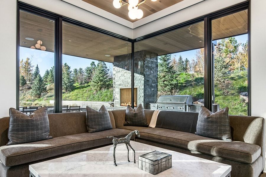 A living room with a large sectional couch and a coffee table.