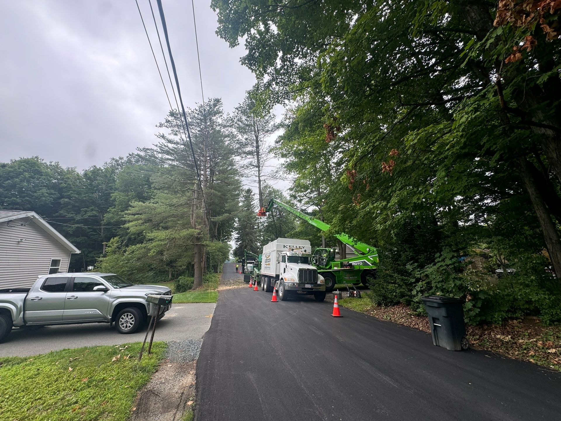 A truck is parked on the side of a road next to a house.
