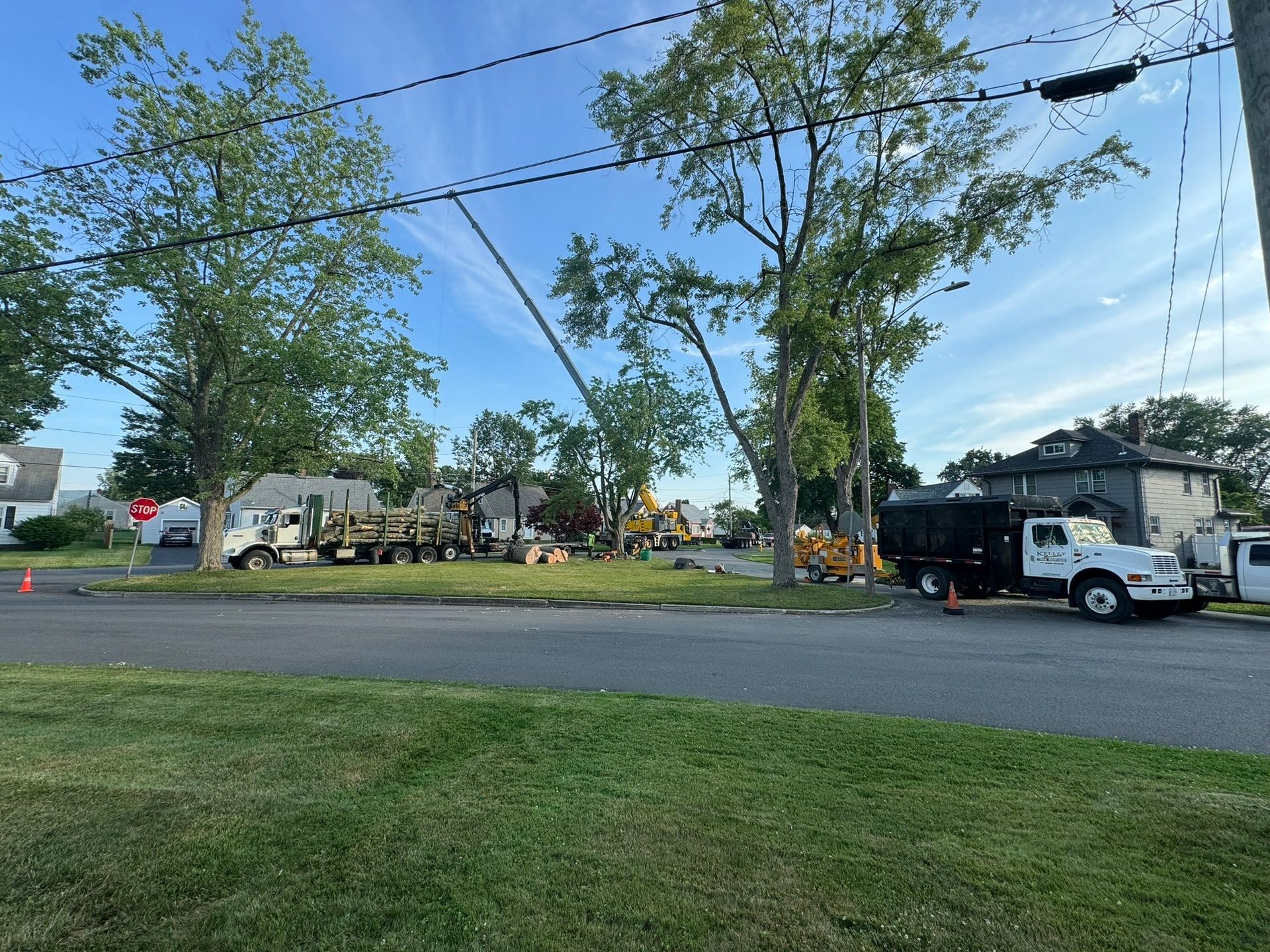 A white truck is parked on the side of the road next to a house.