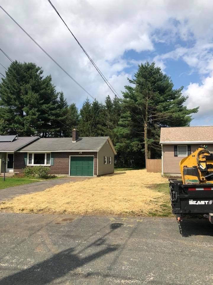 A yellow truck is parked in front of a house.