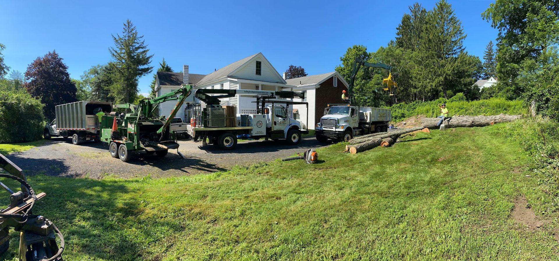 A bunch of trucks are parked in front of a house.
