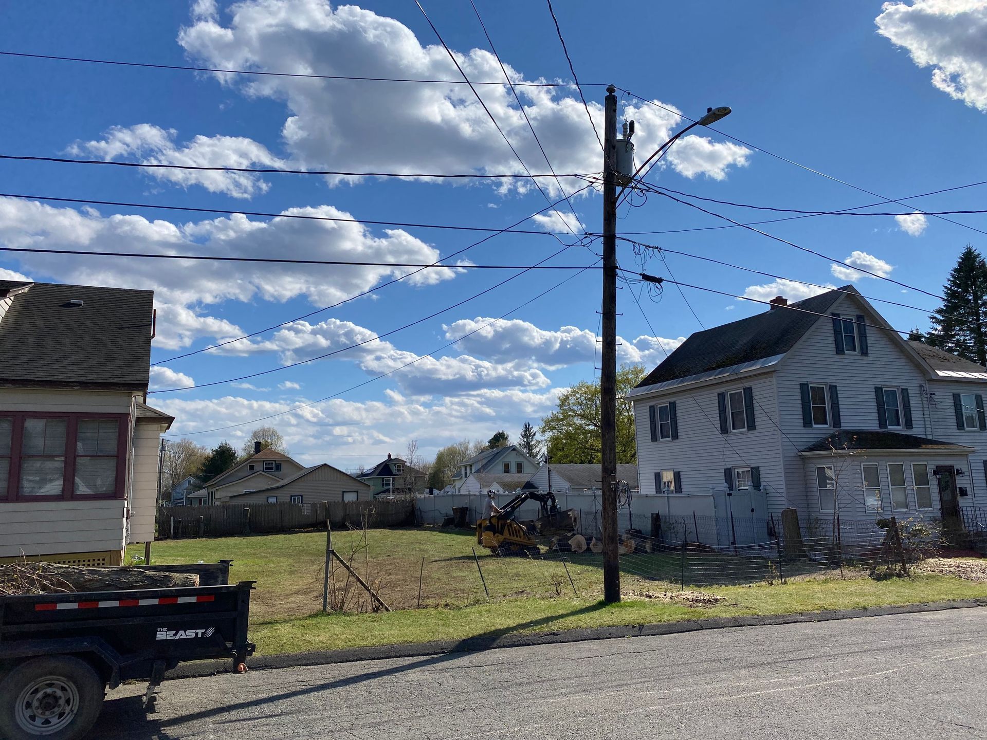 A truck is parked on the side of the road in front of a house.