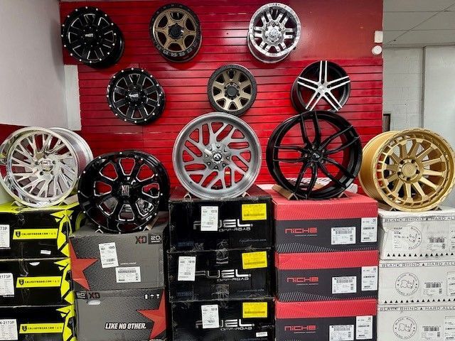 A bunch of wheels are stacked on top of each other in a store