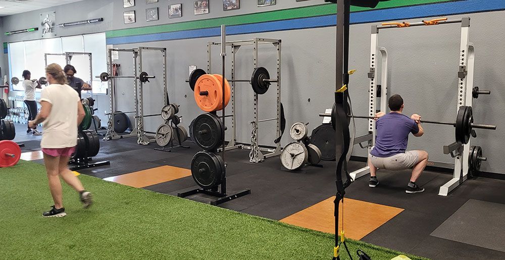 A group of people are working out in a gym.