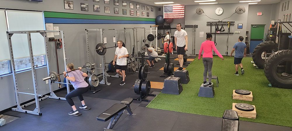 A group of people are working out in a gym.