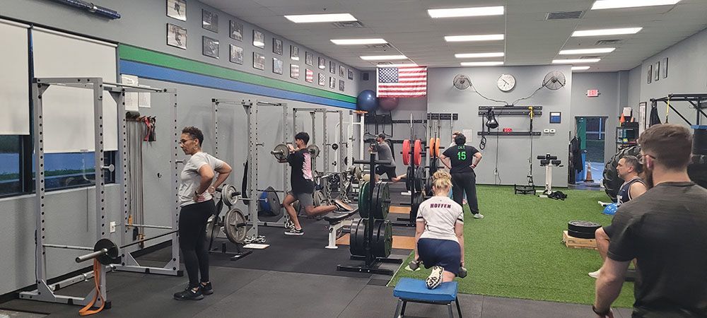 A group of people are working out in a gym.