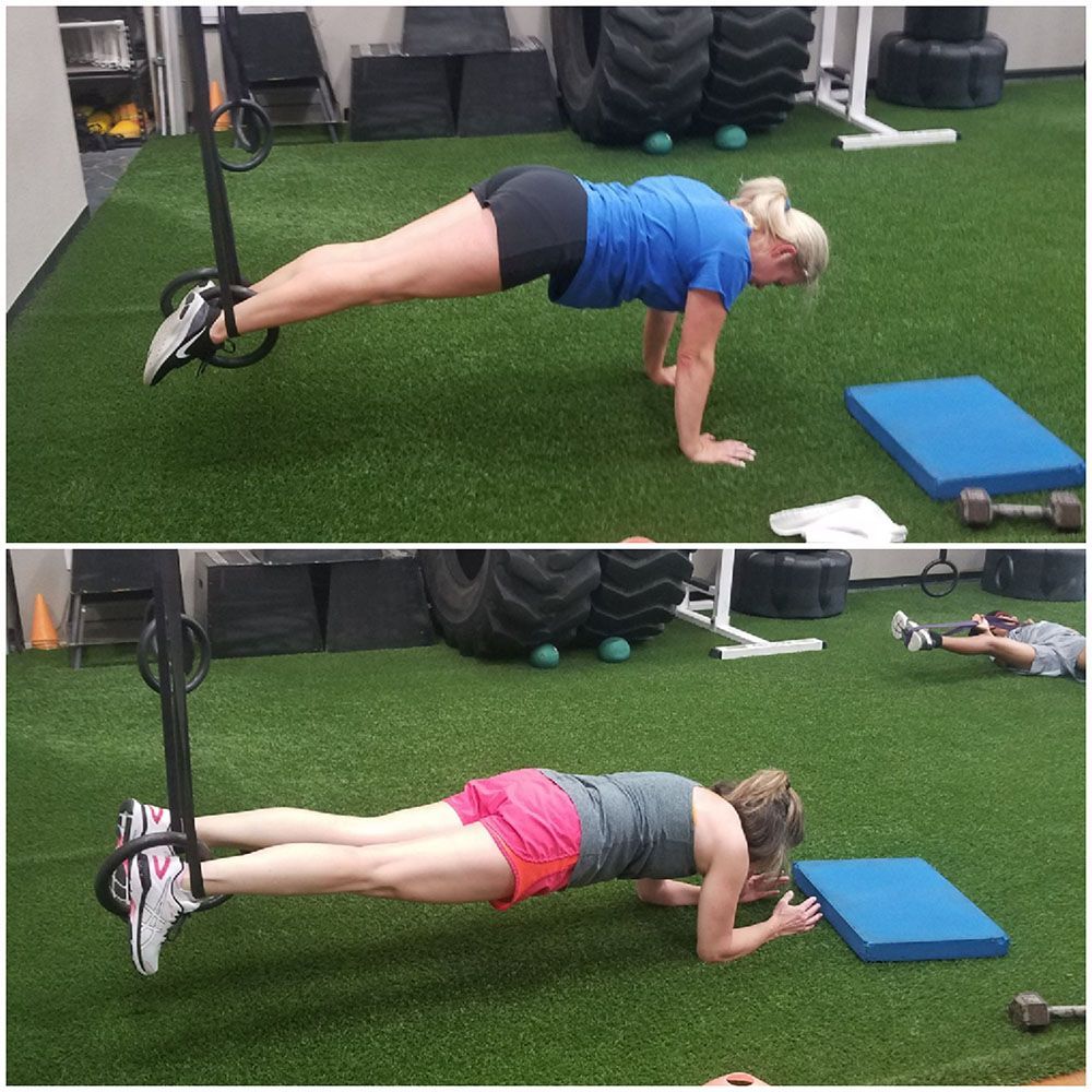 A woman in a blue shirt is doing a plank exercise
