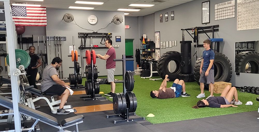 A group of people are working out in a gym.