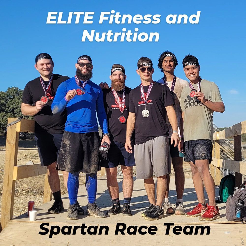 A group of men standing next to each other with medals around their necks.