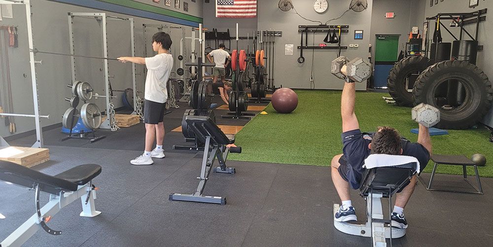A group of people are working out in a gym.