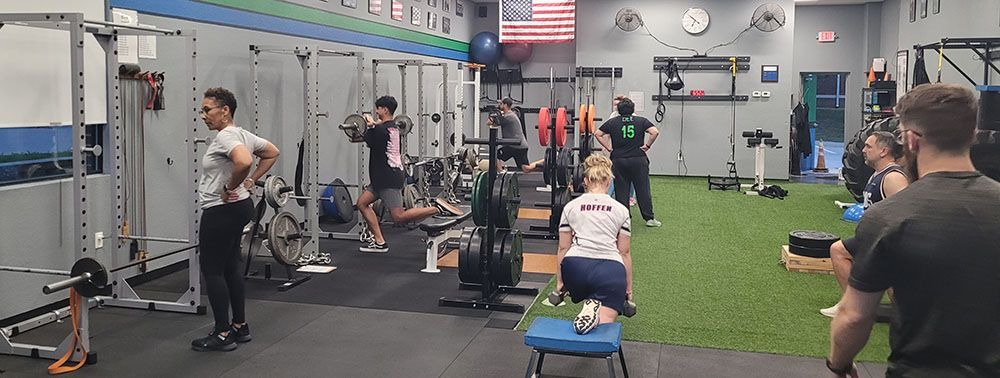 A group of people are working out in a gym.