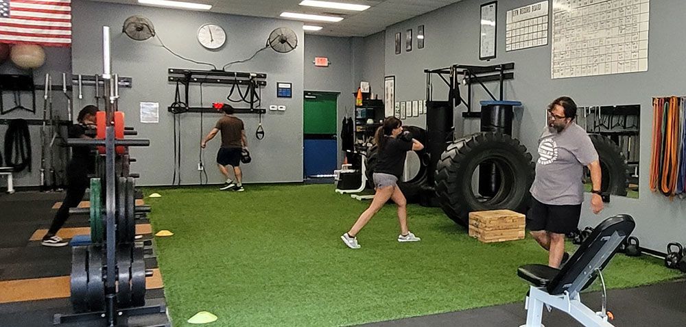 A group of people are working out in a gym.