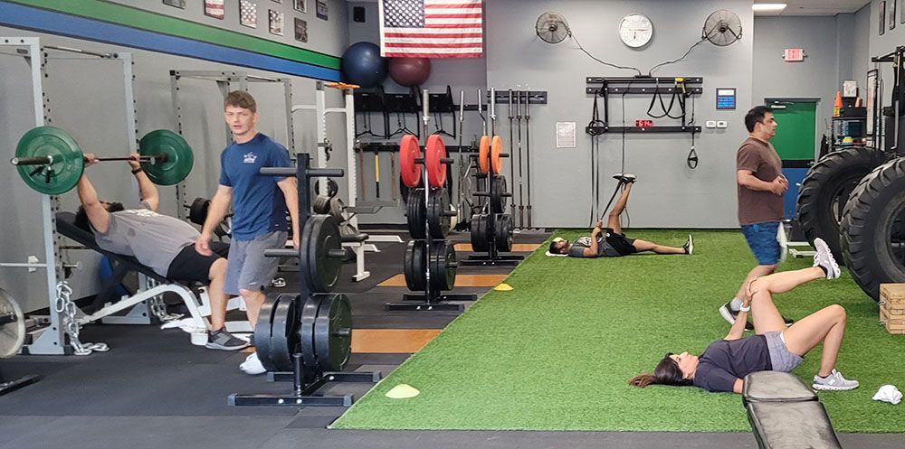 A group of people are working out in a gym.