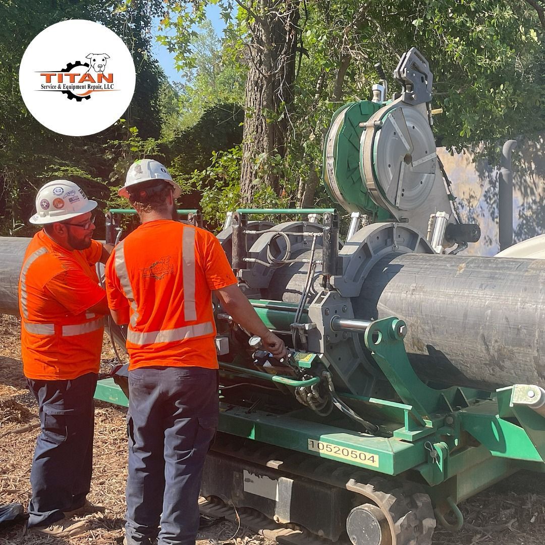 A group of construction workers are working on a large pipe.