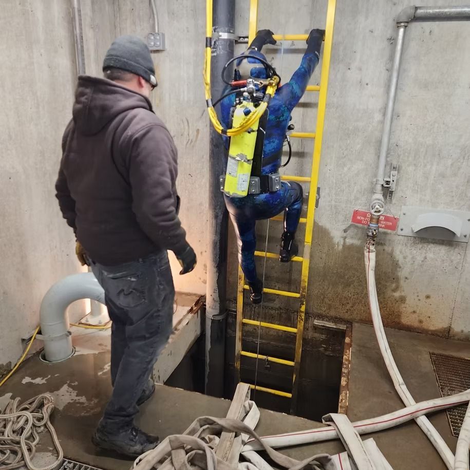 A man is standing next to a man on a ladder
