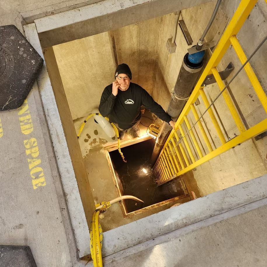 A man is talking on a cell phone while climbing a yellow ladder